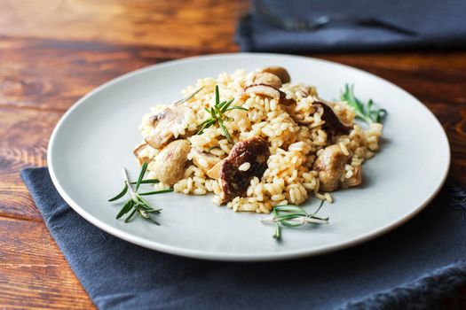 delicious rice with mushrooms and green rosemary, risotto