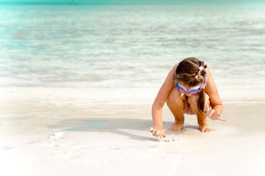 Adorable little girl have fun on the beach