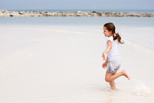 Adorable little girl have fun on the beach