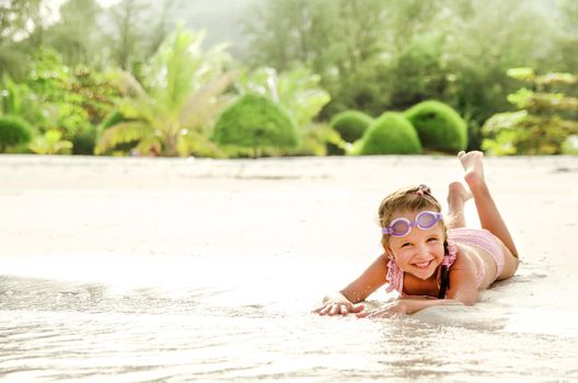 Adorable little girl have fun on the beach