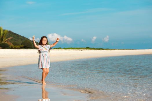 Adorable little girl have fun on the beach