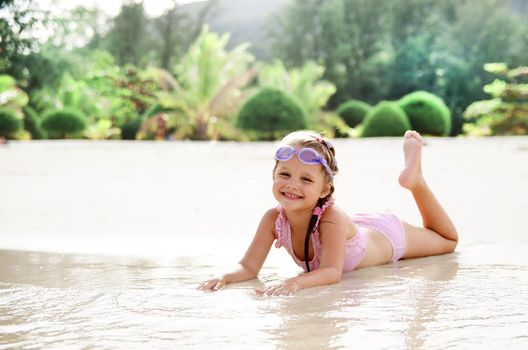 Adorable little girl have fun on the beach