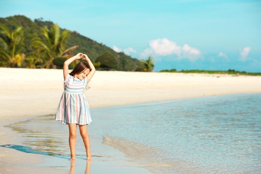 Adorable little girl have fun on the beach