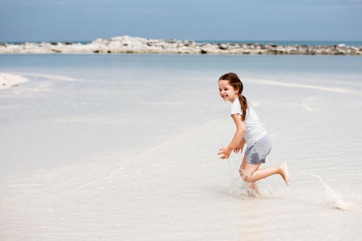 Adorable little girl have fun on the beach