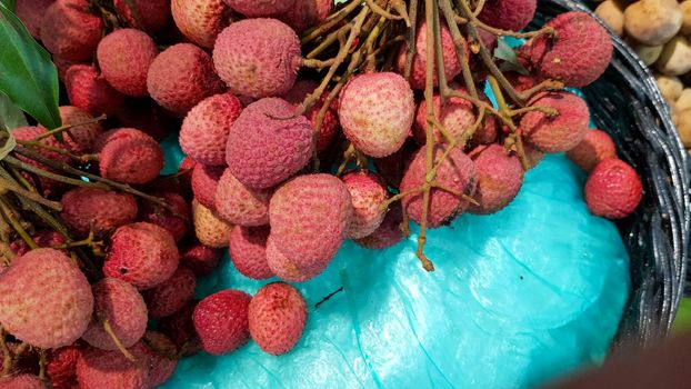 Red lychees are placed for sale in a shop in Thailand.