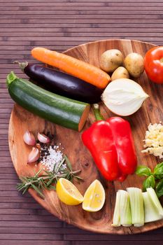 Ingredients vegetables for soup with pesto sauce and basil on a wooden plate. Stock image.