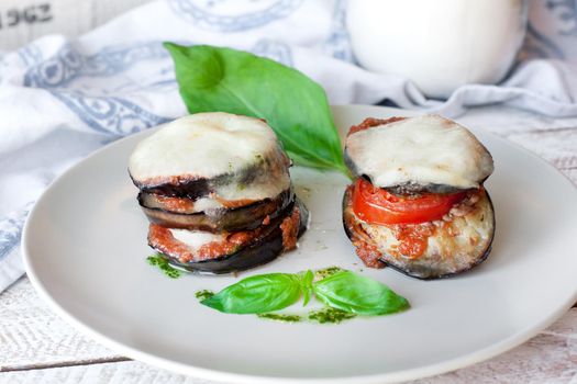 Parmigiana di melanzane: baked eggplant - italy, sicily cousine. On the wooden table.