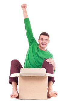 Young delivery man behind the boxes. so funny. isolated white background. Sitting on the floor