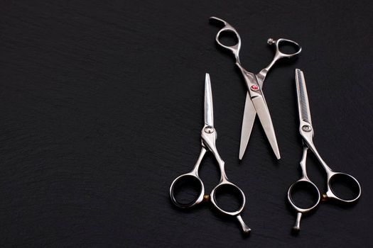 Hairdresser Accessories, Razor for cutting hair with copy space on gray background. set of scissors