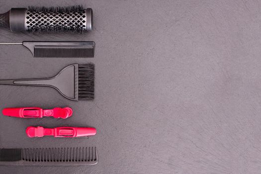 Salon Hairdresser Accessories, pink Comb, application brush, brashing for cutting hair or colored on a black background