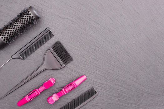 Salon Hairdresser Accessories, pink Comb, application brush, brashing for cutting hair or colored on a black background