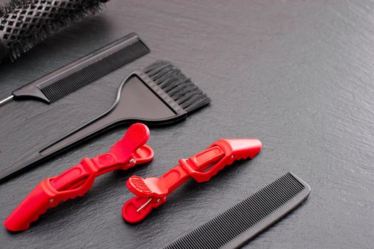 Salon Hairdresser Accessories, pink Comb, application brush, brashing for cutting hair or colored on a black background