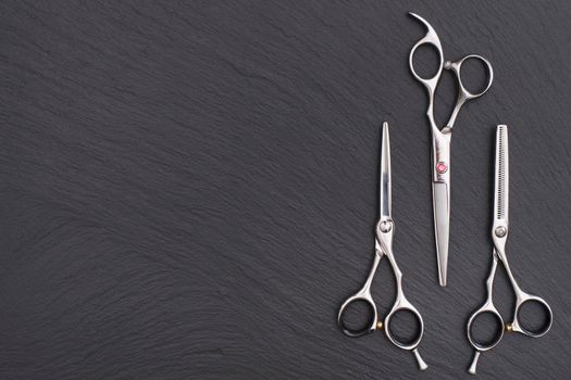 Hairdresser Accessories, Razor for cutting hair with copy space on gray background. set of scissors