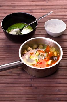 Tuscan vegetable soup with basil pesto in black plate