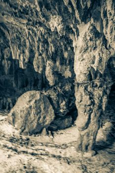 Old black and white picture of Amazing blue turquoise water and limestone cave sinkhole cenote at Santuario de los guerreros in Puerto Aventuras Quintana Roo Mexico.