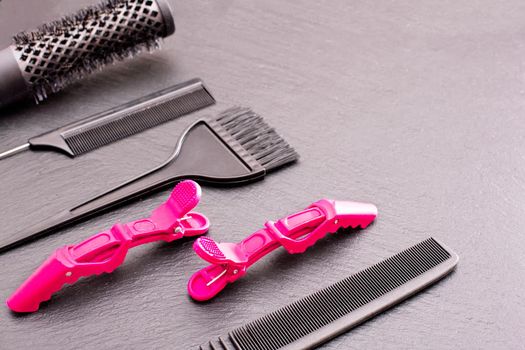 Salon Hairdresser Accessories, pink Comb, application brush, brashing for cutting hair or colored on a black background