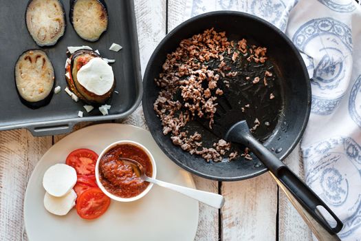 Ingredients for cooking Parmigiana di melanzane: baked eggplant - italy, sicily cousine. On the wooden table.