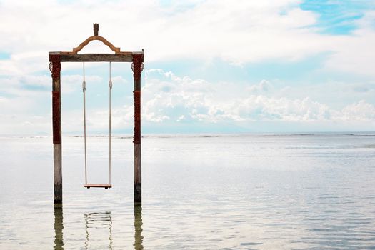 Swing above the sea. Iconic tourist attraction in Gili Trawangan island in Lombok, Indonesia.