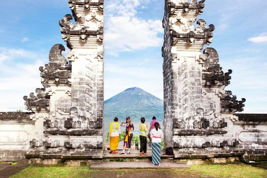 balinese people standing betwen Lempuyang gate. Bali