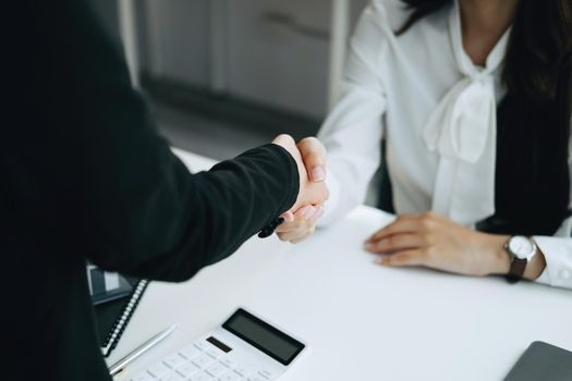 Guarantees, Mortgages, Signings, Insurance, contract, agreement concept, Real Estate Agents are shaking hands with customers to congratulate them after landing a deal.