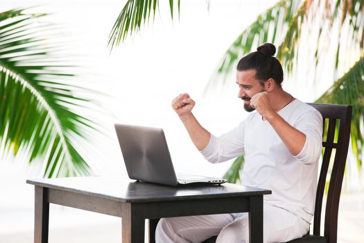 telecommuting, businessman relaxing on the beach with laptop and palm, freelancer workplace, dream job