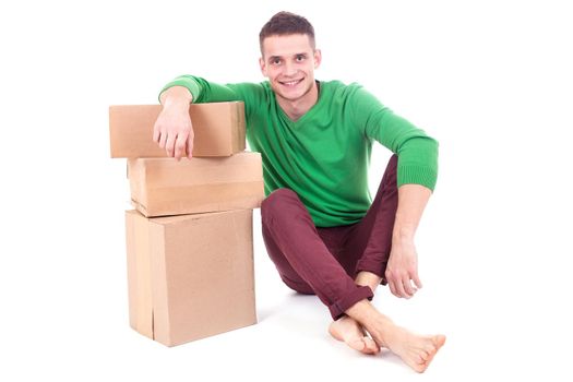 Sad, tired and surprised deliveryman hardly carries the parcel, isolated, white background