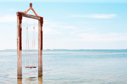 Swing above the sea. Iconic tourist attraction in Gili Trawangan island in Lombok, Indonesia.