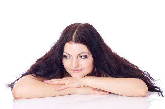 Young woman sitting on a table and thinking, isolated on white.