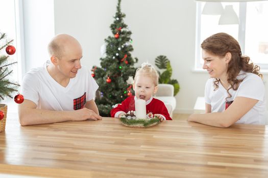 Child girl dressed in christmas dress with cochlear implants having fun at home - hearing aid and innovating technologies for treatment deafness