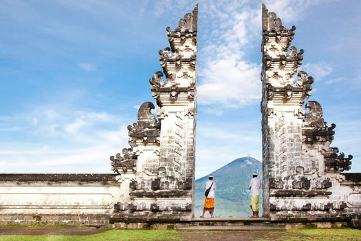 balinese people standing betwen Lempuyang gate. Bali