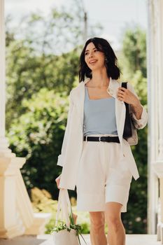 Vertical Portrait of Cheerful Brunette Woman Holding Shopping Eco Bag Outdoors at Sunny Summer Day