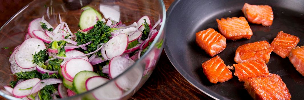 Ingredients. Broiled salmon with radish and spinach, served on wooden table. View from above, top studio shot