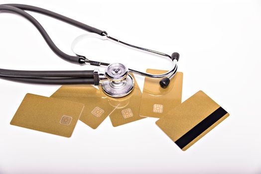 Health care costs conceptual image: stethoscope and pile of money on a medical chart, symbol of health care costs or health insurance, isolated on white background