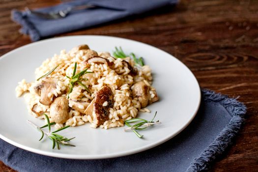 delicious rice with mushrooms and green rosemary, risotto