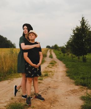 Mother and son outdoors, happy family lifestyle portrait in the park.