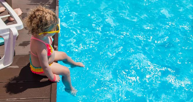 Baby swims in the pool. Selective focus. Child.