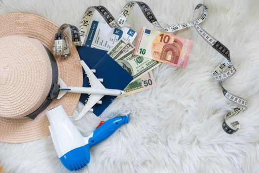 toy plane, hair dryer, hat, money.