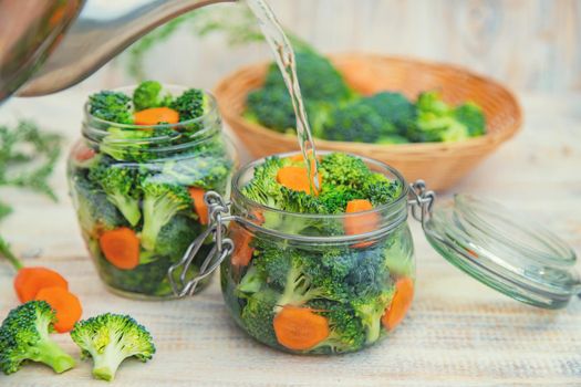 Preservation of broccoli with carrots in jars. Selective focus. nature.