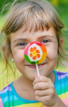 Lollipops in the hands of child. Selective focus.