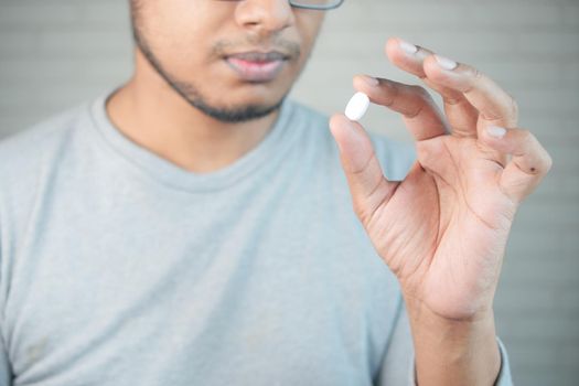 upset man hand holding medical pills .