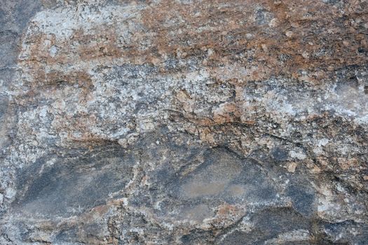 Close-up texture of a natural river bank stone wall in a mountain forest in northern Thailand. Stone and ecology concept.