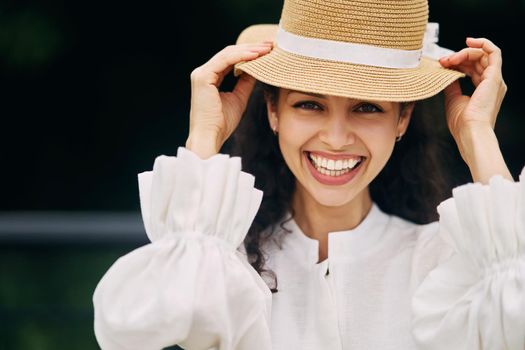 Young beautiful girl in a hat in a summer park. High quality photo