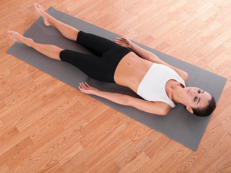 Shot of a beautiful young woman lying on an exercise mat.