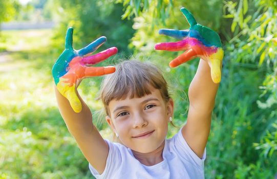 child with painted hands and legs. Selective focus.