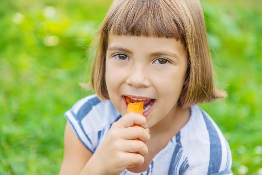 child eats vegetables carrots. Selective focus. food.