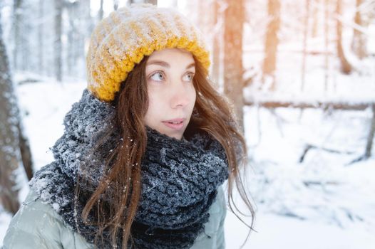 Photo portrait of young attractive caucasian woman, happy positive smile, cheerful good mood in winter park, looking away. Copy space.