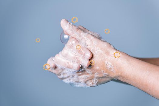 hands washing with soap foam to remove the coronavirus over blue background, virus and bacteria prevention concept, horizontal photo, copy space for text