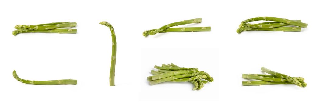 Bunch of fresh green asparagus isolated on white background. Big set freshly picked asparagus with water drops isolated on white background