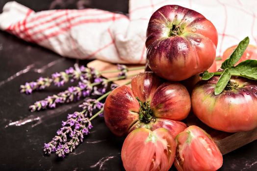 Beautiful fresh tiger tomatoes on dark background