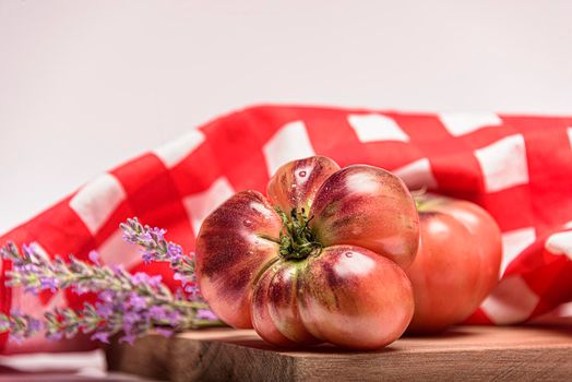 Fresh tomatoes in a plate on a dark background. Harvesting tomatoes. Top view